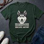 Green Comfort Colors t-shirt with a husky graphic and text on a dark surface with shoes and jeans.