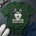 Green Comfort Colors t-shirt with a husky graphic and text on a dark surface with shoes and jeans.