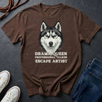 Brown Comfort Colors t-shirt with a husky graphic and text on a dark surface with shoes and jeans.