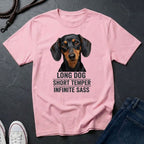 Pink Comfort Colors t-shirt with a dachshund graphic and text on a dark surface