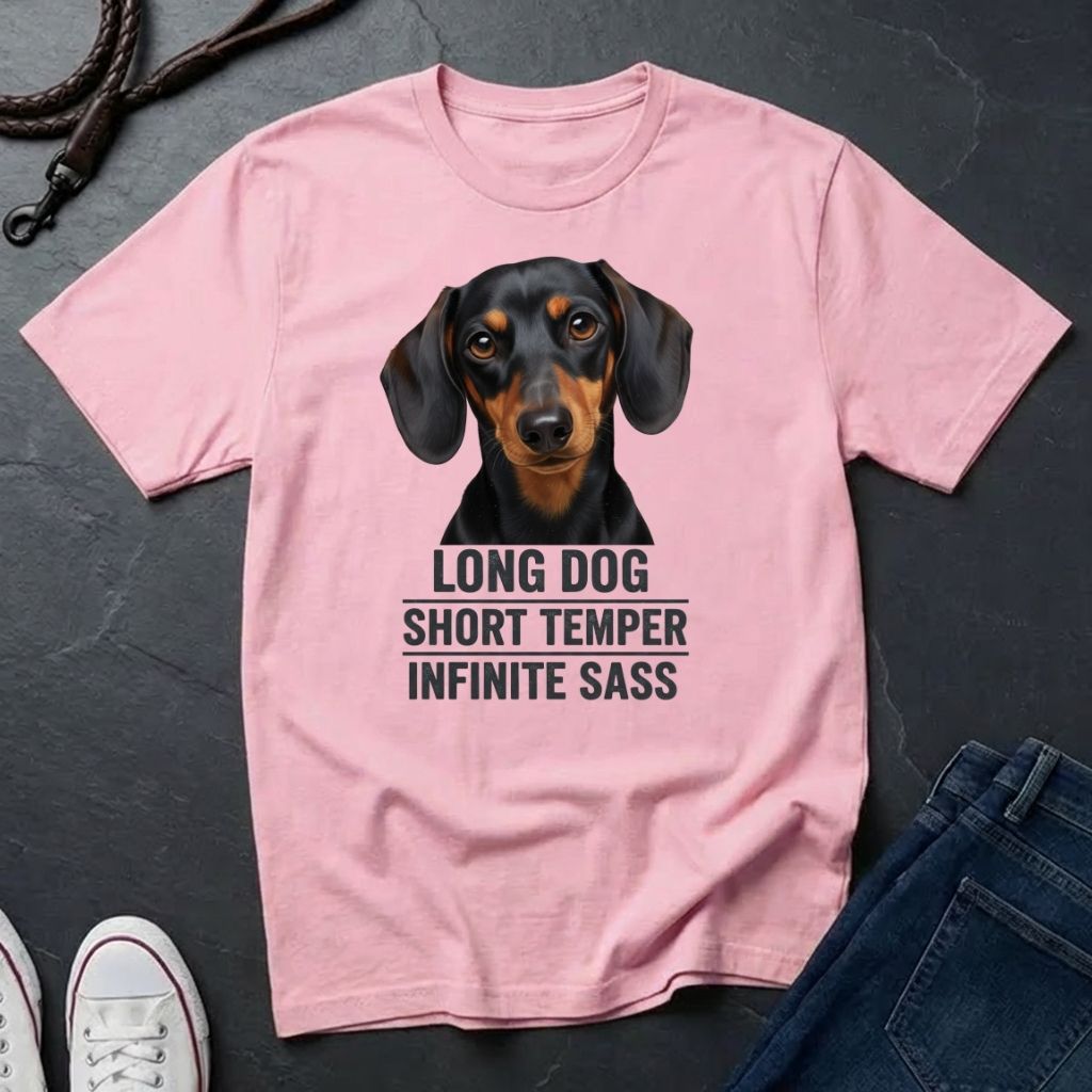 Pink Comfort Colors t-shirt with a dachshund graphic and text on a dark surface
