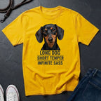 Yellow Comfort Colors t-shirt with a dachshund graphic and text on a dark surface.