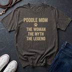 Gray Comfort Colors t-shirt with 'Poodle Mom: The Woman, The Myth, The Legend' text on a dark surface with shoes and jeans.