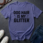Purple Comfort Colors t-shirt with 'Dog Hair is My Glitter' text on a dark surface with shoes and jeans.