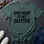 Green Comfort Colors t-shirt with 'Dog Hair is My Glitter' text on a dark surface with shoes and jeans.