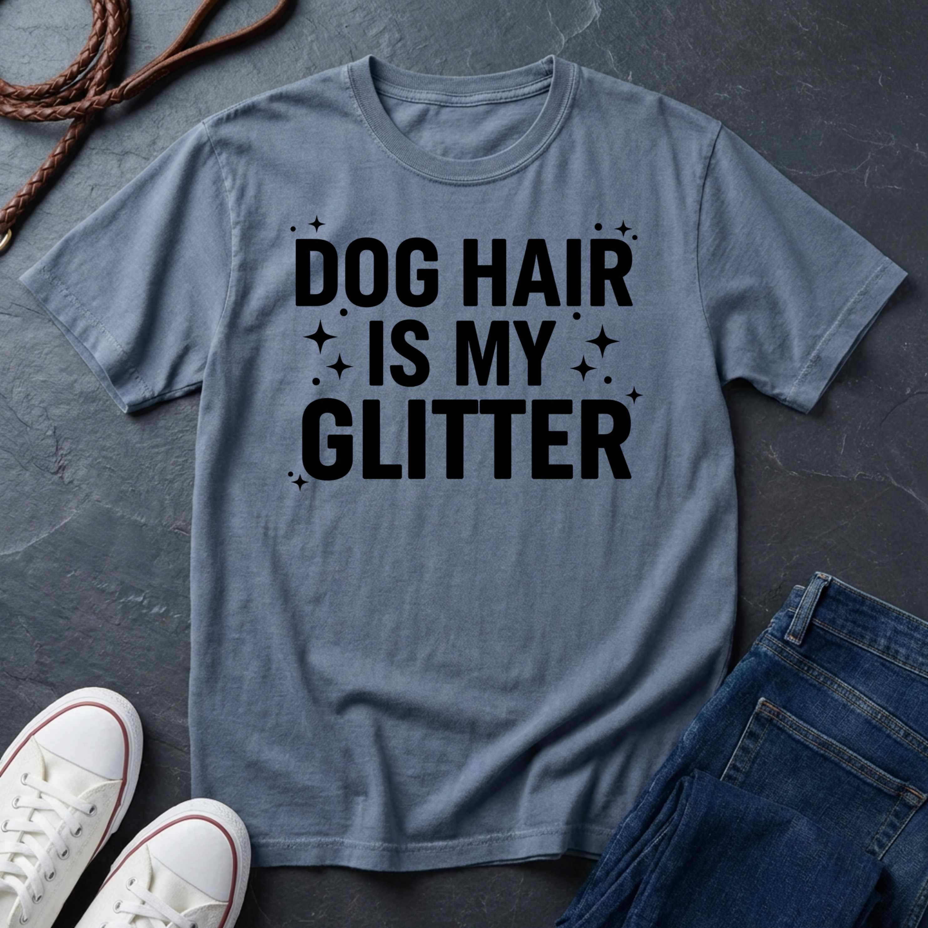 Blue Comfort Colors t-shirt with 'Dog Hair is My Glitter' text on a dark surface with shoes and jeans.