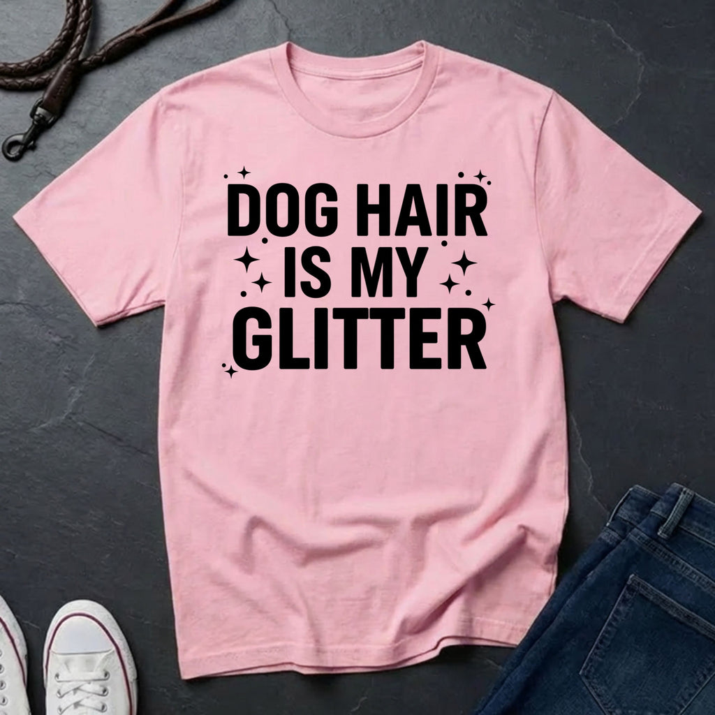 Pink Comfort Colors t-shirt with 'Dog Hair is My Glitter' text on a dark surface with jeans and shoes.