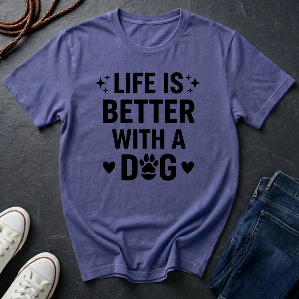 Purple Comfort Colors t-shirt with 'Life is better with a dog' text on a dark surface with shoes and jeans.
