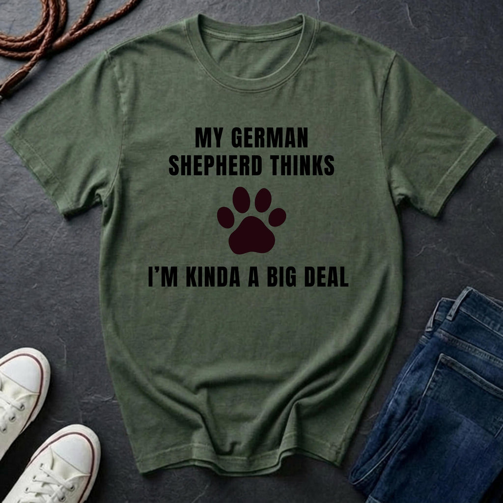 Green Comfort Colors t-shirt with text and paw print graphic on a dark surface with shoes and jeans.