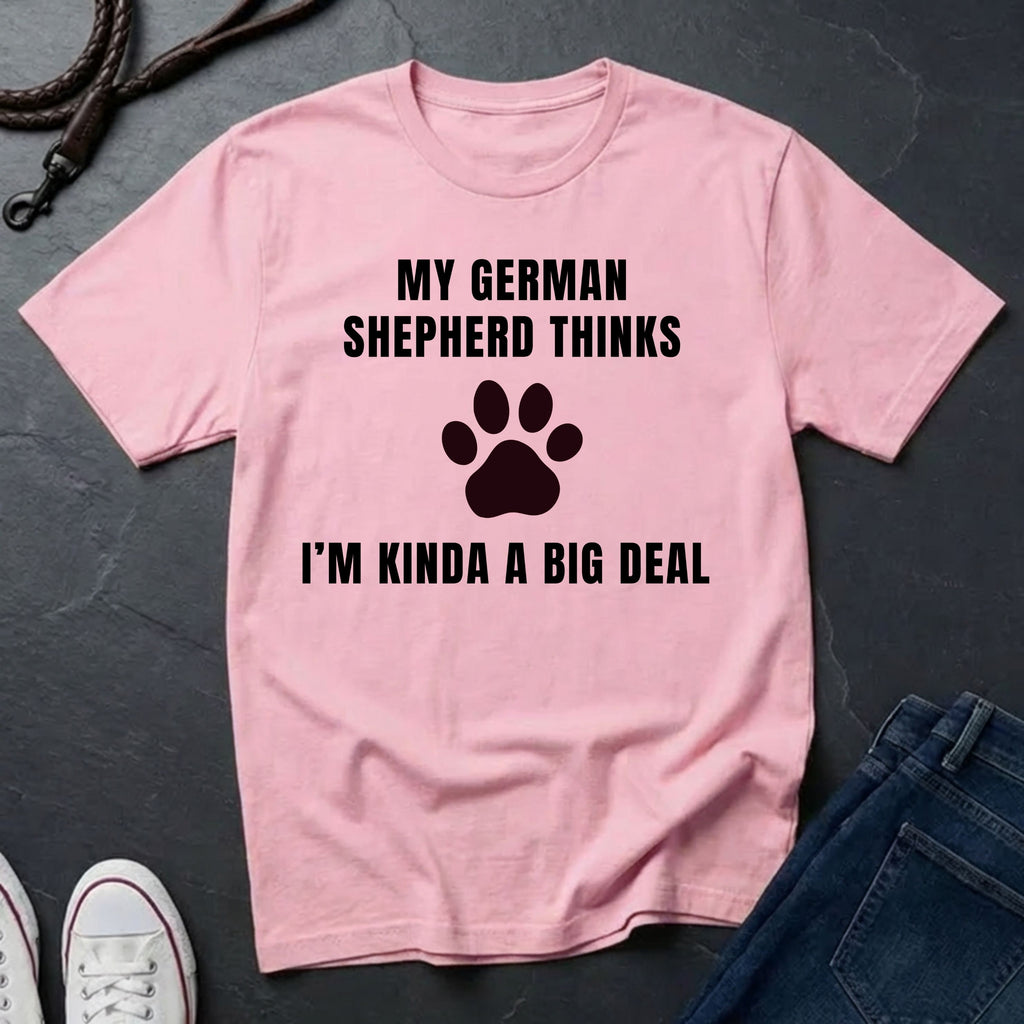 Pink Comfort Colors t-shirt with text and paw print design on a dark surface with jeans and shoes.