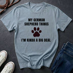 Gray Comfort Colors t-shirt with text and paw print graphic on a dark surface with shoes and jeans.
