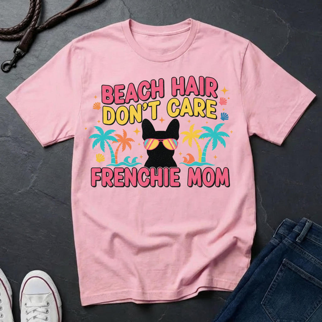 Pink Comfort Colors t-shirt with 'Beach Hair Don't Care Frenchie Mom' design on a dark surface.
