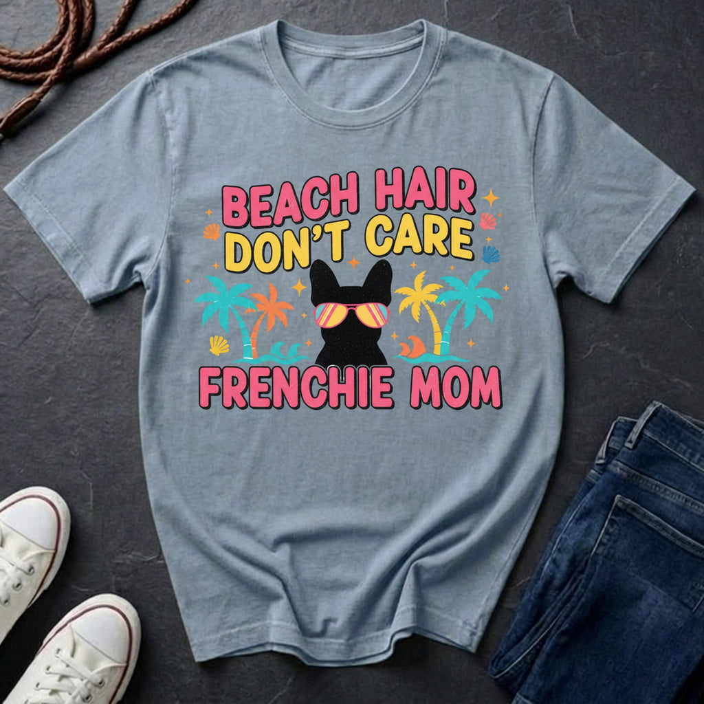 Gray Comfort Colors t-shirt with 'Beach Hair Don't Care Frenchie Mom' design on a dark surface with shoes and jeans.