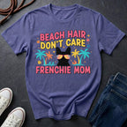 Purple Comfort Colors t-shirt with 'Beach Hair Don't Care Frenchie Mom' design on a dark surface.