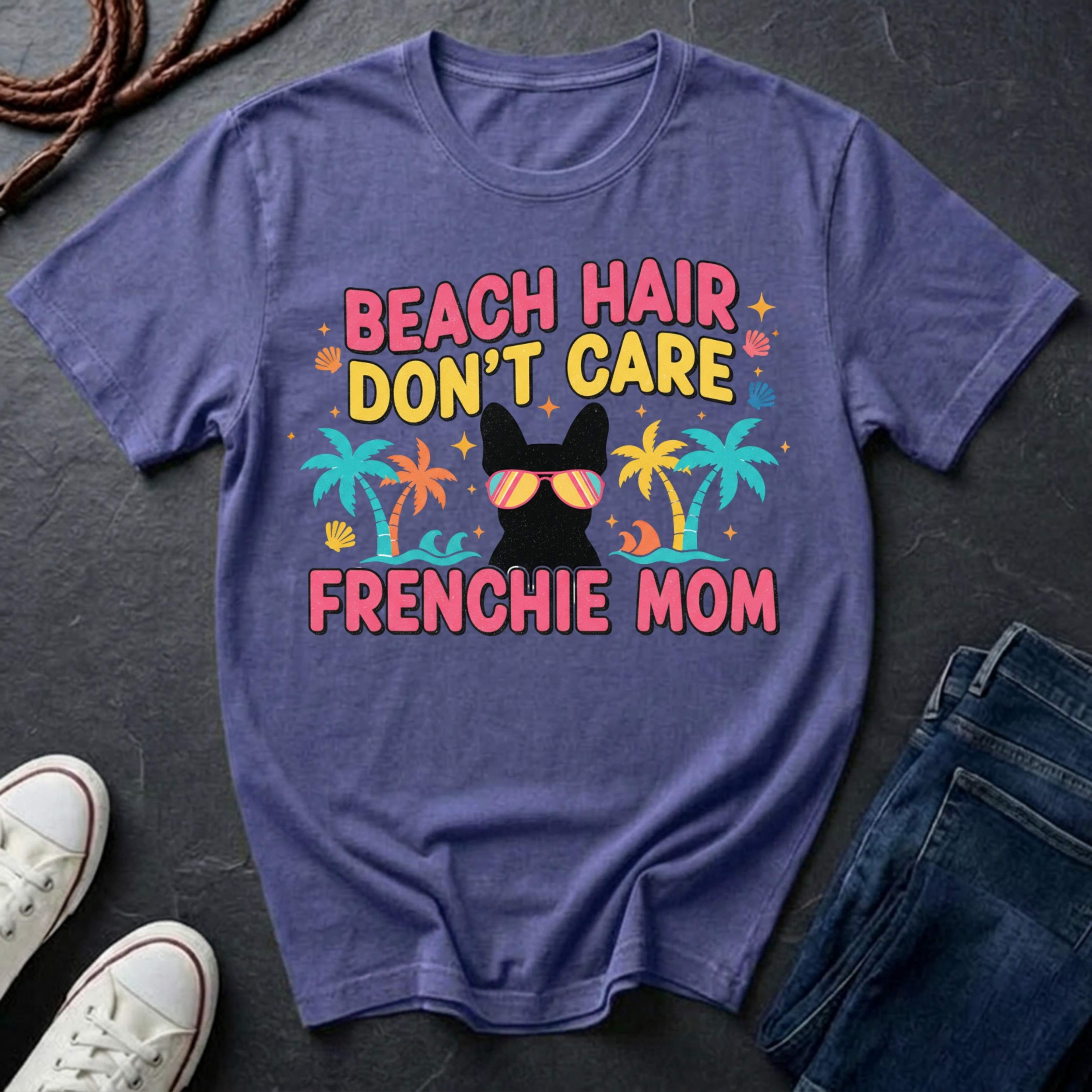 Purple Comfort Colors t-shirt with 'Beach Hair Don't Care Frenchie Mom' design on a dark surface.