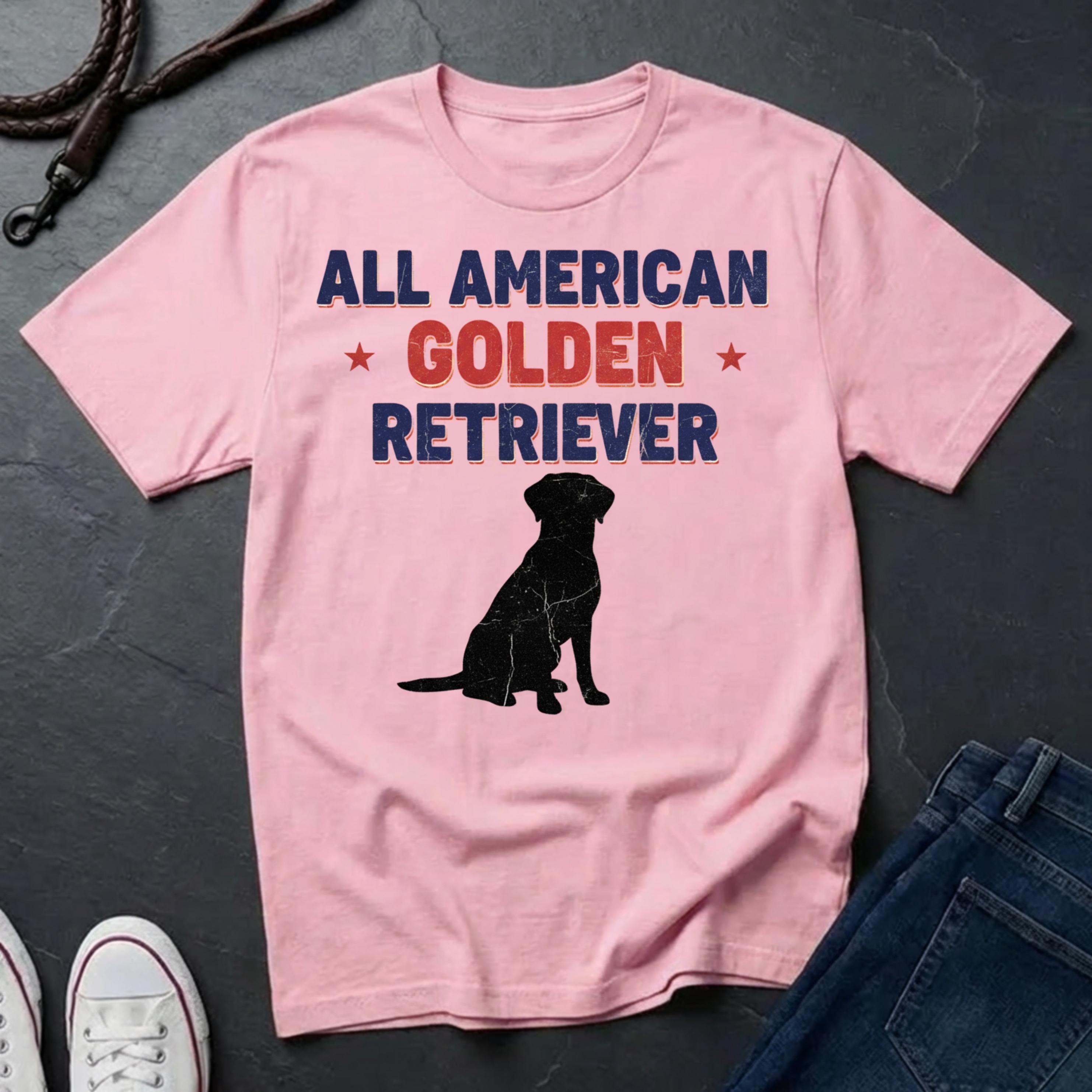 Pink Comfort Colors t-shirt with 'All American Golden Retriever' text and dog silhouette on a dark surface.