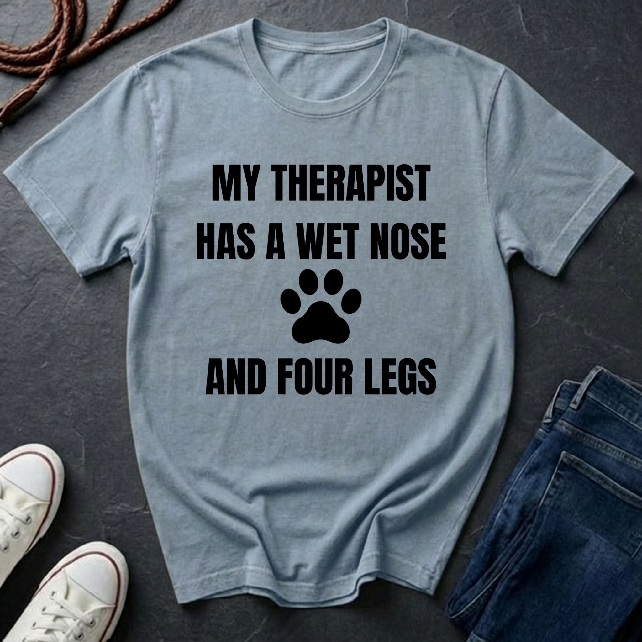 Gray Comfort Colors t-shirt with 'My therapist has a wet nose and four legs' text and paw print on a dark surface.