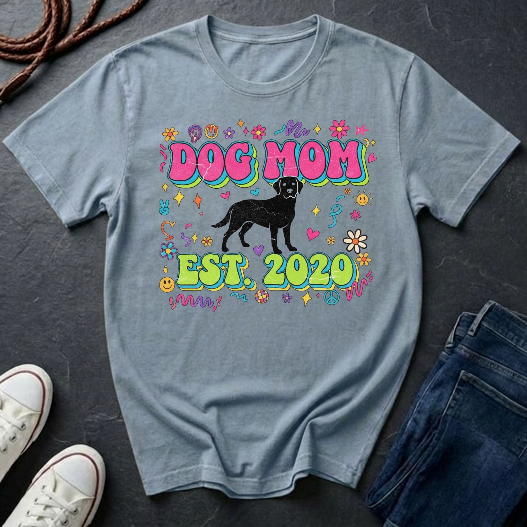 Gray Comfort Colors t-shirt with 'Dog Mom Est. 2020' design on a dark surface with shoes and jeans.