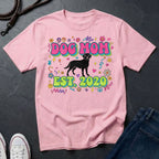 Pink Comfort Colors t-shirt with 'Dog Mom Est. 2020' design on a dark surface.