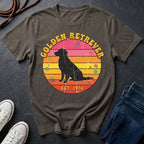 Brown Comfort Colors t-shirt with a Golden Retriever design on a dark surface with shoes and jeans.
