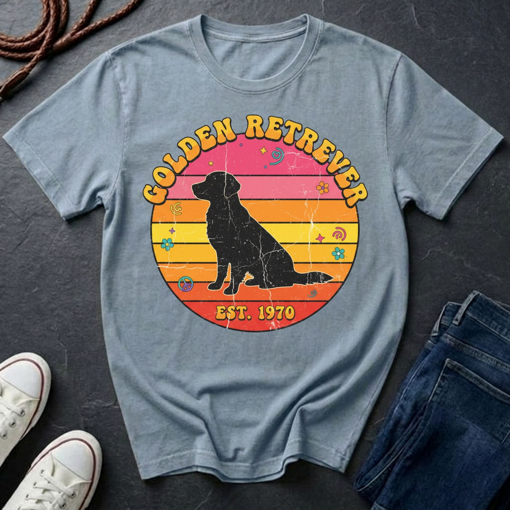 Blue Comfort Colors t-shirt with a Golden Retriever graphic and text on a dark surface with shoes and jeans.