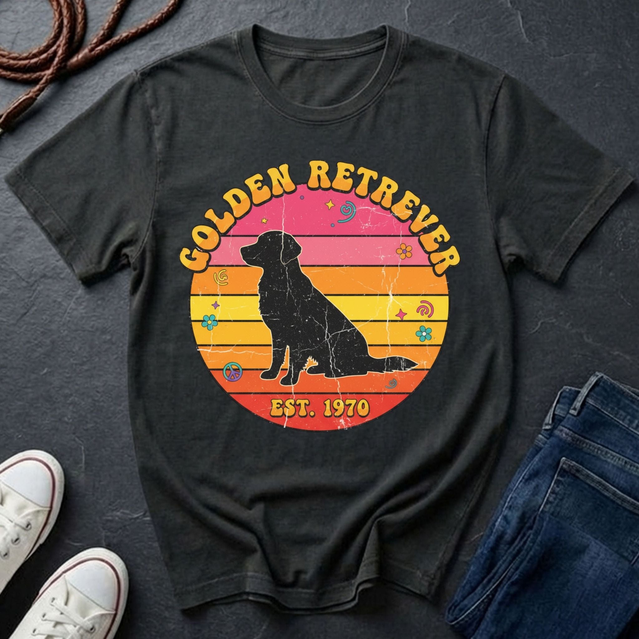 Black Comfort Colors t-shirt with a Golden Retriever graphic and text on a dark surface with shoes and jeans.