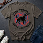 Brown Comfort Colors t-shirt with 'Paw-Triotic 230th USA Anniversary' design featuring a black dog silhouette on a dark surface.