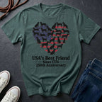 Green Comfort Colors t-shirt with dog heart design and text on a dark surface with shoes and jeans.