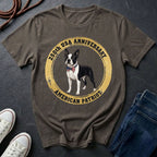 Brown Comfort Colors t-shirt with a dog graphic and text on a dark surface with shoes and jeans.