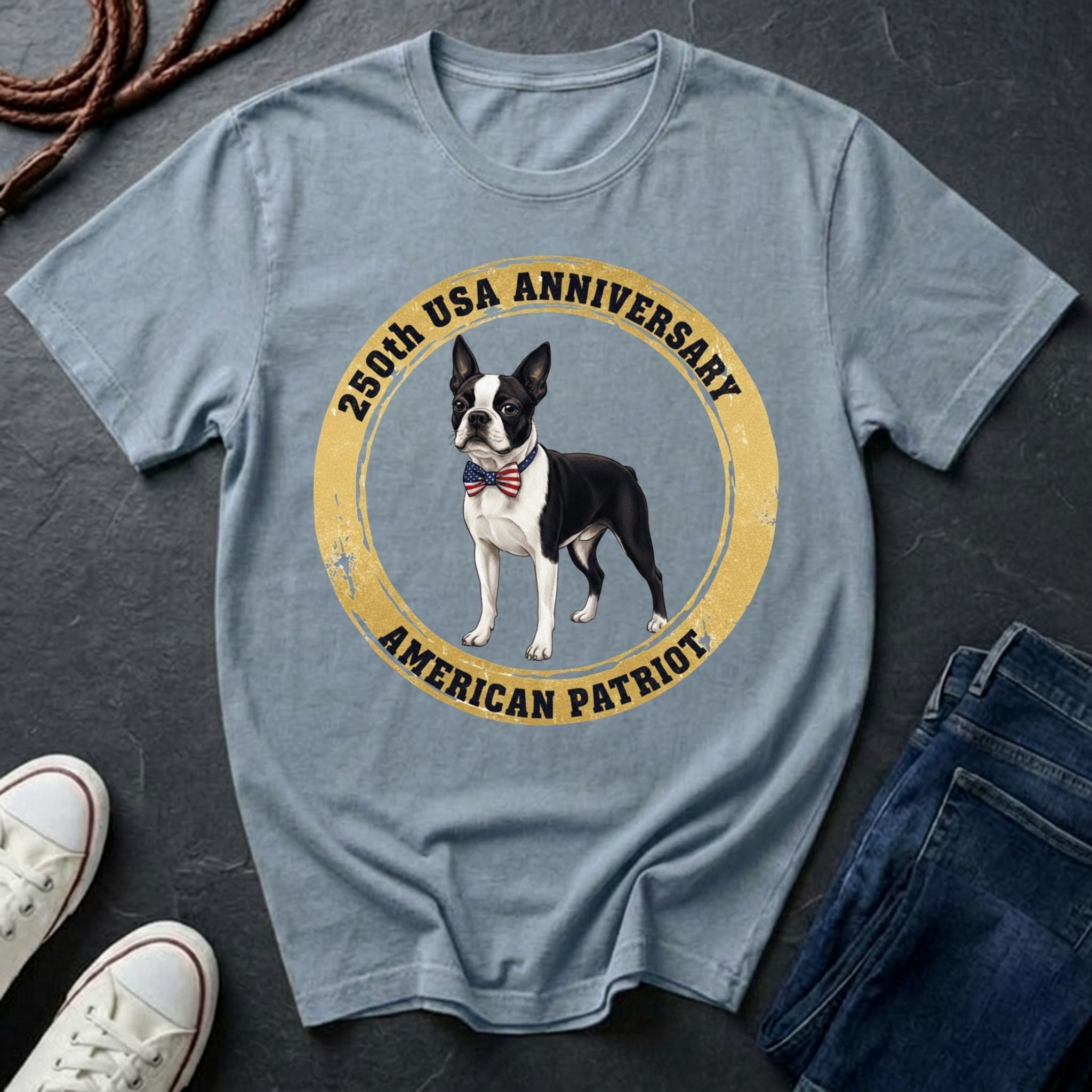 Blue Comfort Colors t-shirt with a dog graphic and text on a dark surface with shoes and jeans.