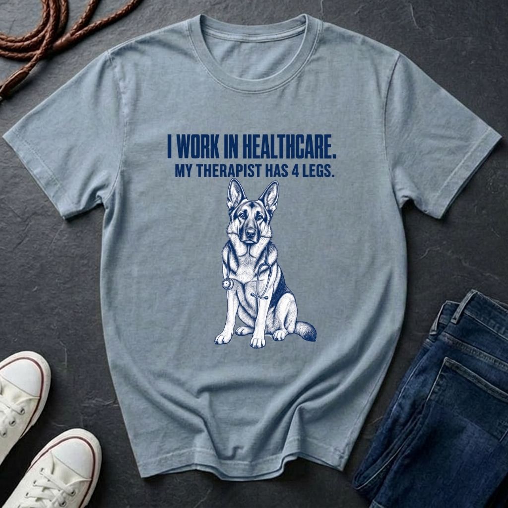 Gray Comfort Colors t-shirt with a dog graphic and text on a dark surface with shoes and jeans.