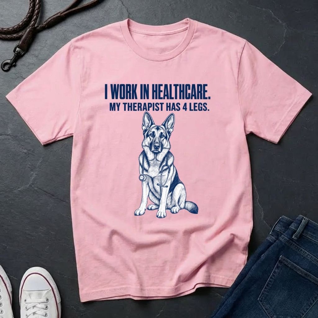 Pink Comfort Colors t-shirt with a dog graphic and text on a dark surface