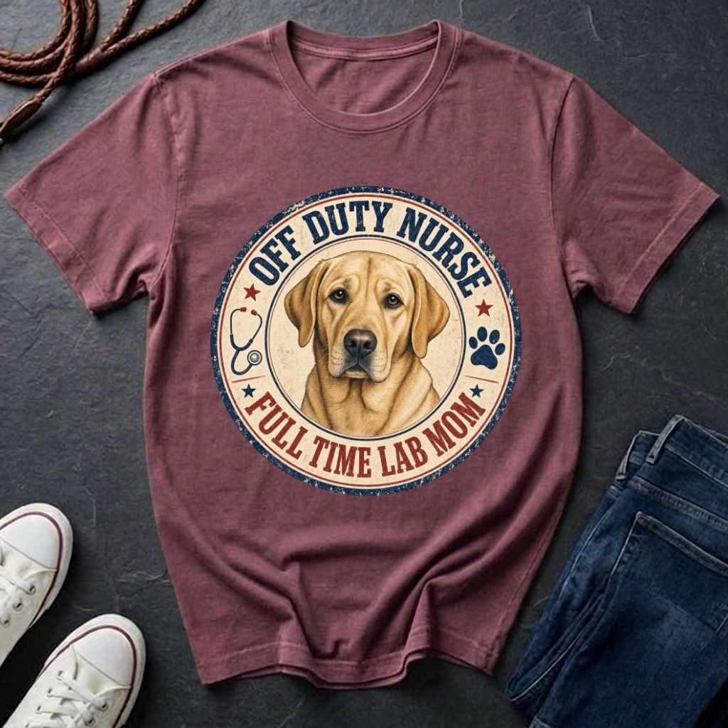 Maroon Comfort Colors t-shirt with a dog graphic and text on a dark surface with shoes and jeans.