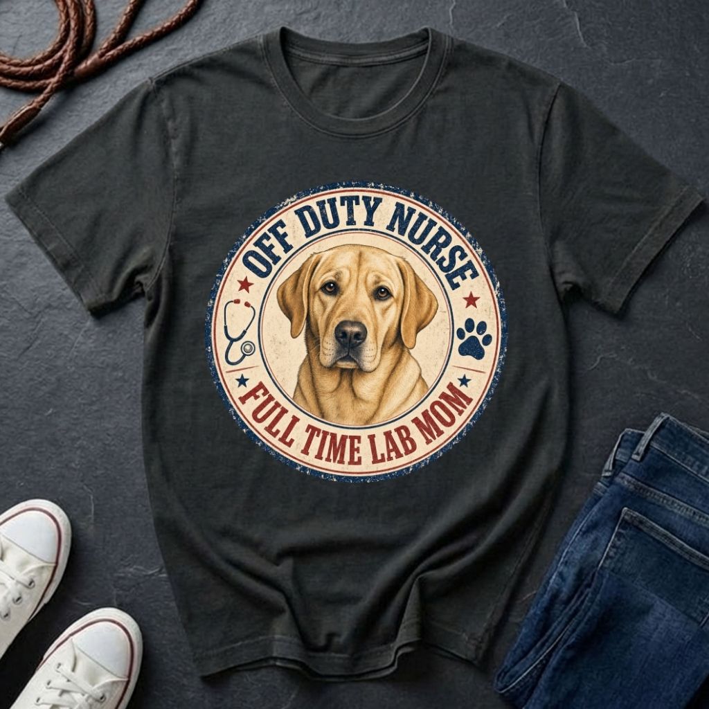 Black Comfort Colors t-shirt with a dog graphic and text on a dark surface with shoes and jeans.