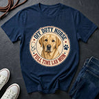 Navy blue Comfort Colors t-shirt with a dog graphic and text on a dark surface with shoes and jeans.
