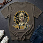 A dark brown t-shirt featuring a graphic of a Chinese Crested dog inside a circular emblem with the text 'GOT YOUR 6' below it. The shirt is styled in a flat-lay arrangement on a dark slate background, accompanied by white sneakers, a coiled rope, and a pair of blue jeans.