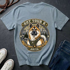Akita Got Your 6 t-shirt design featuring a tactical distressed badge with Akita portrait and mountain backdrop on Comfort Colors tee in chambray